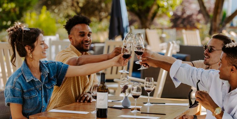 Four friends raise their glasses to Seghesio—Zinfandel and red blends that bring bold flavor and unforgettable moments to every shared toast.